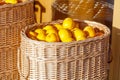 A basket of lemons is sitting on a table Royalty Free Stock Photo