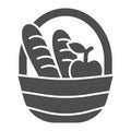 Basket with loaves and apple solid icon, food concept, Picnic basket full of delicious fruits and bread sign on white