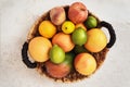 Basket with a lot of different fruits such as apple, peach, orange, lemon grapefruit and mango