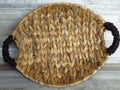 Basket made of Calamus growing in the water. Beautiful Handmade Woven Bamboo / Cane Basket on bleached oak background. Top view.