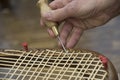 a basket maker weaves a basket
