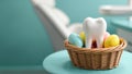 basket with model of human molar tooth surrounded by Easter painted eggs on the background of modern dental clini Royalty Free Stock Photo