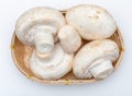 Basket of mushrooms champignon, cut feet, Agaricus Bisporus raw uncooked.