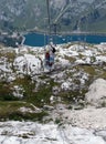 basket of an open cable car with mum and baby and the lake in th