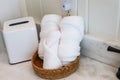 A basket of organized clean rolled white towels on a bathroom counter in a guest bathroom Royalty Free Stock Photo