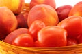 Basket of peaches and tomatoes close-up