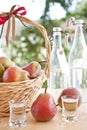 A basket with pears and pear schnapps