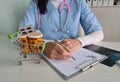 Basket with pills and pharmacist writing prescription Royalty Free Stock Photo