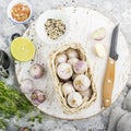 Basket with pink single-edged garlic on a gray marble background with ingredients for meat marinade on shish kebabs, bbq Royalty Free Stock Photo