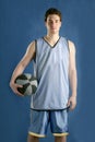 Basket player young man over blue