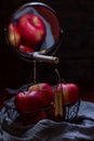 A basket of red apples with the inscription Snow White is reflected in a mirror, recreating the atmosphere of the fairy tale