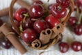 Basket with red cherries with stems and jar with cherries Royalty Free Stock Photo