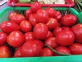 A basket of red tomatoes display for sale at grocery store Royalty Free Stock Photo