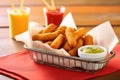 basket of seasoned corn dogs with mixed fries