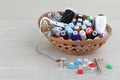 Basket of sewing supplies on a wood surface