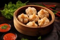 a basket of steamed vegetable momos with spicy dip