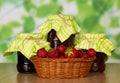 Basket with strawberry and three jam banks Royalty Free Stock Photo