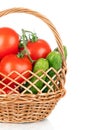 Basket of tomatoes and cucumbers. Fresh vegetables on w Royalty Free Stock Photo