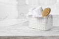 Basket, towels and bath brush on wood over blurred bathroom Royalty Free Stock Photo