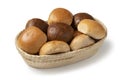 Basket with a variation of white and brown buns of bread close up on white background