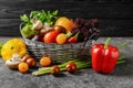 Basket with various fresh vegetables on dark table Royalty Free Stock Photo