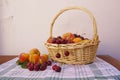 A basket with various types of fruits on a kitchen towel and blank rustic background Royalty Free Stock Photo