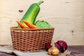 Basket with vegetables: cabbage, zucchini, pumpkin, carrots, beets and onions on wooden table. Royalty Free Stock Photo