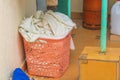 A basket for washing clothes with bedding is located in the utility room. Concept about household chores for cozy living Royalty Free Stock Photo