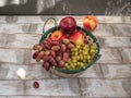 Basket with white grapes and apples in a wooden background Royalty Free Stock Photo