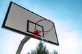 Basketball backboard with hoop and net against the blue sky. Royalty Free Stock Photo