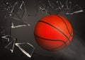 Basketball ball breaking up glass against grey background