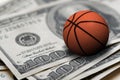Basketball ball on 100 dollars bills closeup Royalty Free Stock Photo