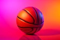 Basketball ball with glowing lines on colorful purple and pink neon light background. Futuristic sport concept. Ball for playing Royalty Free Stock Photo