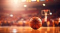 Basketball ball lying on floor on sport arena, stadium with sun light coming from windows. Blurred background with sport Royalty Free Stock Photo