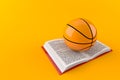 Basketball ball on open book