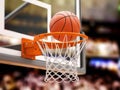 Basketball ball scoring the winning points on basketball net hoop on basketball arena
