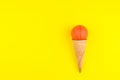 Basketball ball toy in ice cream waffle cone on yellow background in minimal style. Concept sports entertainment. Top view Copy