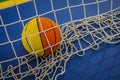 Basketball ball trapped inside a net of a handball Royalty Free Stock Photo