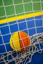 Basketball ball trapped inside a net of a handball Royalty Free Stock Photo