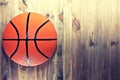 Basketball ball on wooden hardwood floor.