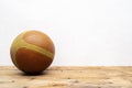 Basketball balls for sports and games are placed on a wooden table with white plaster