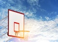 Basketball board with hoop net at the basket ball play ground on sunny day with clear blue sky and light clouds. Copy space. Clipp Royalty Free Stock Photo