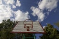 Basketball board with a net. Old, wooden planks. Painted. Located on a background of blue sky with clouds. Sport games in the yard Royalty Free Stock Photo