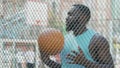 Basketball coach eagerly waiting for team at sports ground, outdoor training