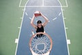 Basketball concept. Man jumping and making a slam dunk playing streetball, basketball. Urban authentic.