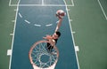 Basketball concept. Man jumping and making a slam dunk playing streetball, basketball. Urban authentic.