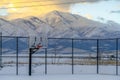 Basketball court and mountain covered with snow