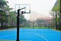 Basketball court with old wood backboard.blue sky and white clouds on background