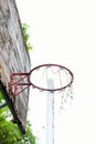 Basketball court with old wood backboard.blue sky and white clouds on background. Old Stadium.