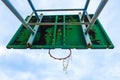 Basketball court with old wood backboard.blue sky and white clouds on background. Old Stadium.